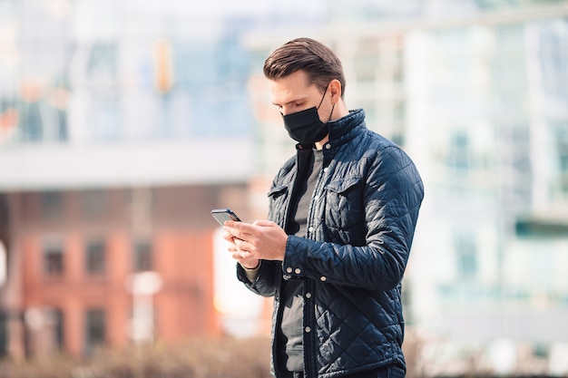 Man wearing a mask on a modern building.