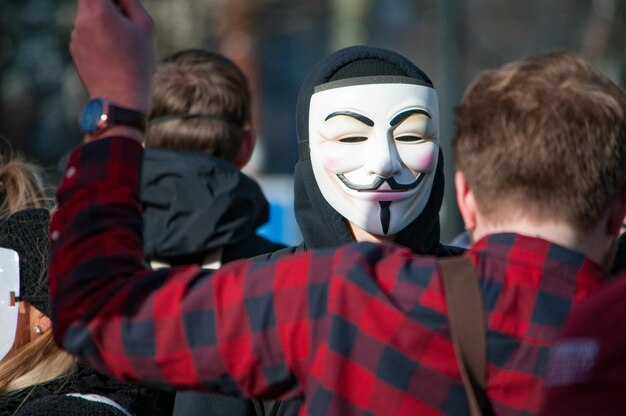 Man wearing mask during protest in city
