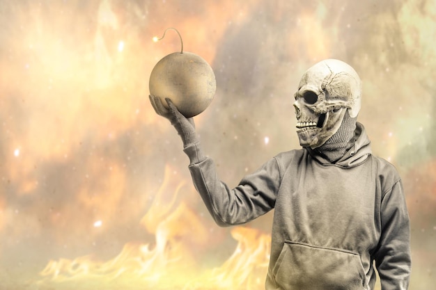 A man wearing a mask standing while holding a ball bomb