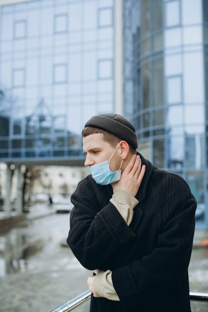 A man wearing a mask on the street. protection against virus and grip