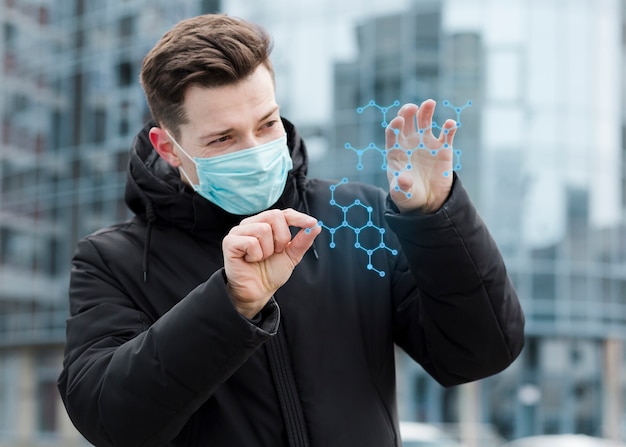 Man wearing medical mask and looking at molecular structure