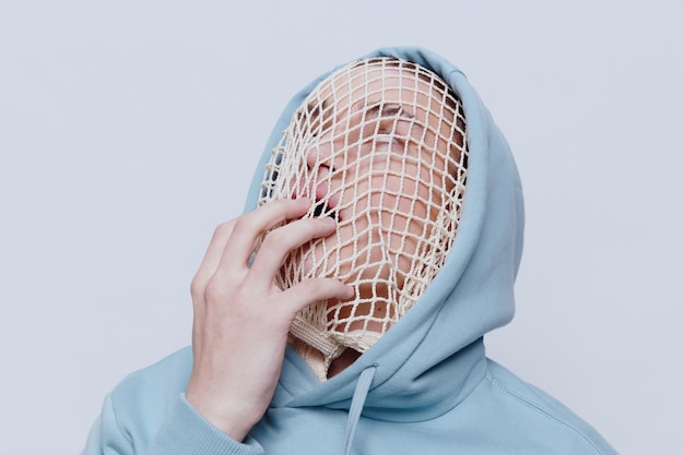 Man wearing mesh bag against white background