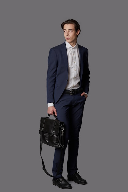 man wearing navy suit and business black bag