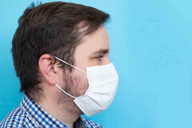 Man wearing protective mask on blue