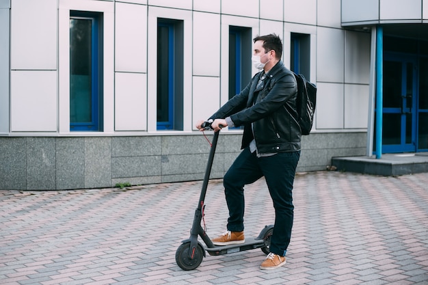 man wearing protective mask using scooter