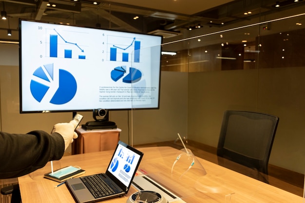 Man wearing rubber glove with a remote control slide presentation