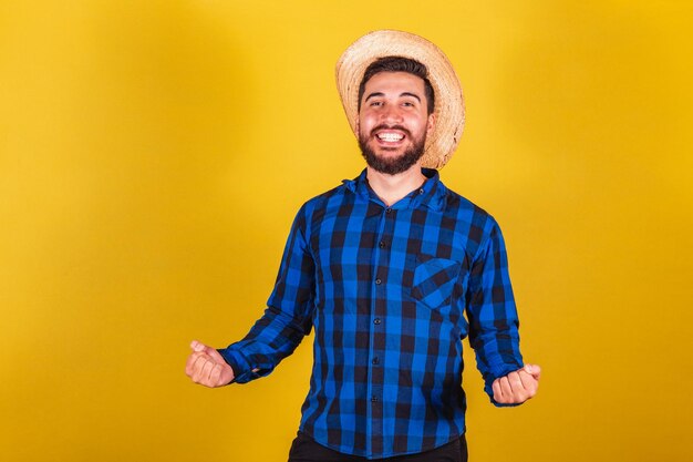 Man wearing typical clothes for festa junina celebrating supporter victory