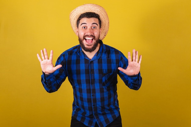 Man wearing typical clothes for Festa Junina Expression of surprise wow amazing