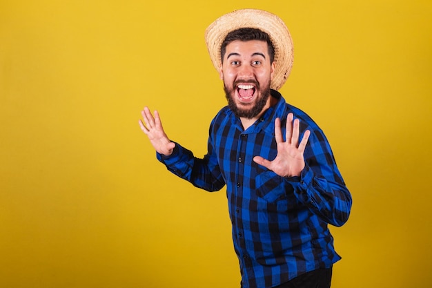 Man wearing typical clothes for Festa Junina Expression of surprise wow amazing