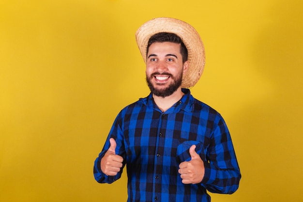 Man wearing typical clothes for Festa Junina thumb up positive affirmative closeup photo