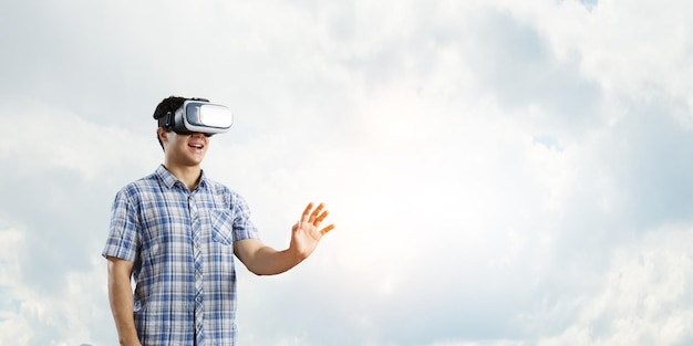 Man wearing virtual reality goggles. Mixed media