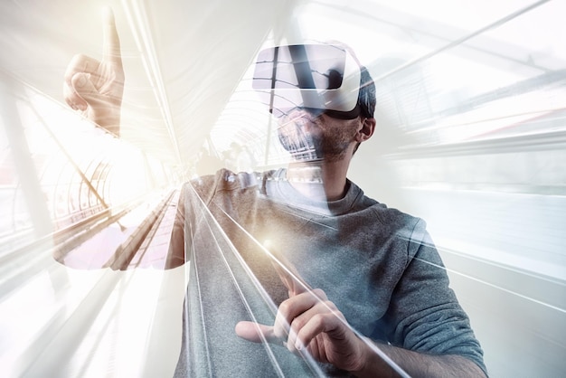 man wearing a virtual reality goggles with a futuristic background. ideal for websites and magazines layouts