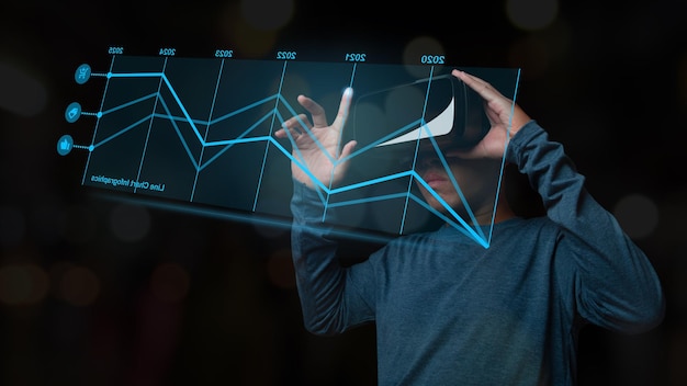 Мужчина в гарнитуре VR показывает растущую статистику торговли на фондовом рынке с виртуальной голограммой