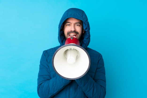 Man wearing winter jacket over isolated wall