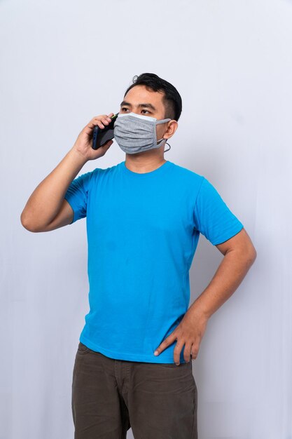 A man wears a medical mask and a cloth mask to protect from the covid-19 virus person