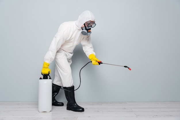 man wears white protective suit and mask