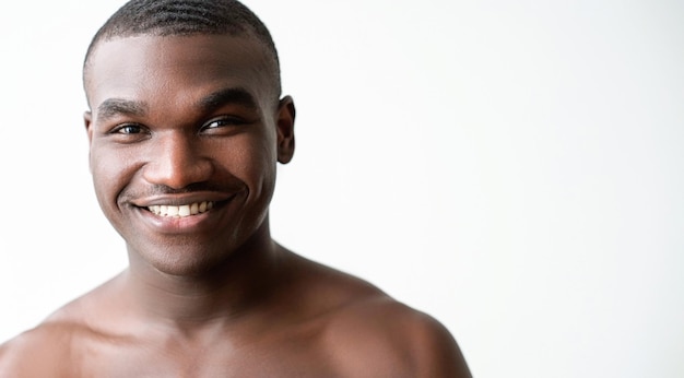 Man wellness skincare hygiene confident positive happy handsome shirtless guy face with toothy smile