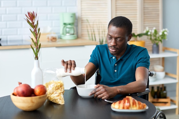 Man in Wheelchair Enjoying Breakfast