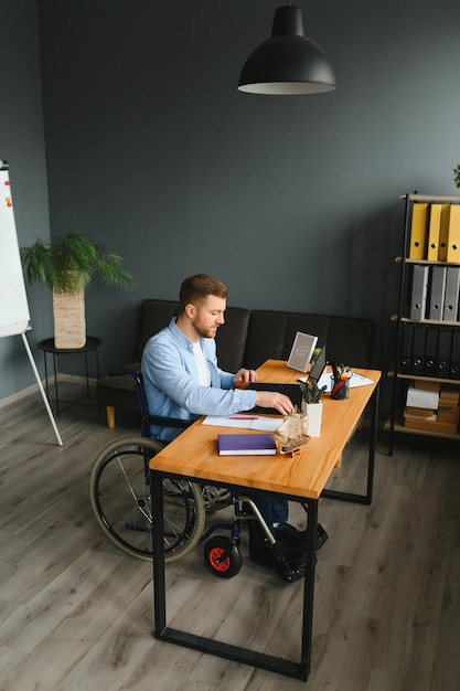 Man in wheelchair at home or in office