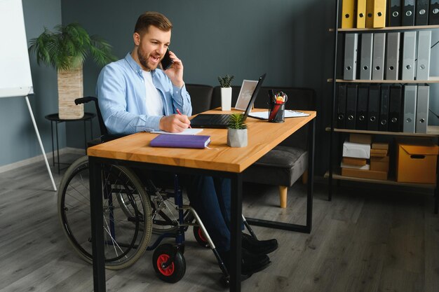 Man in wheelchair at home or in office