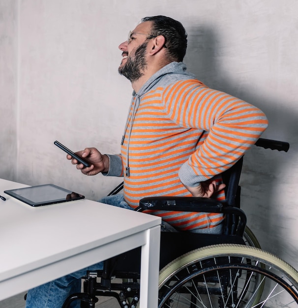 man in wheelchair wincing in pain