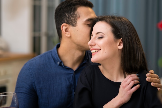 Man whispering something to his girlfriend