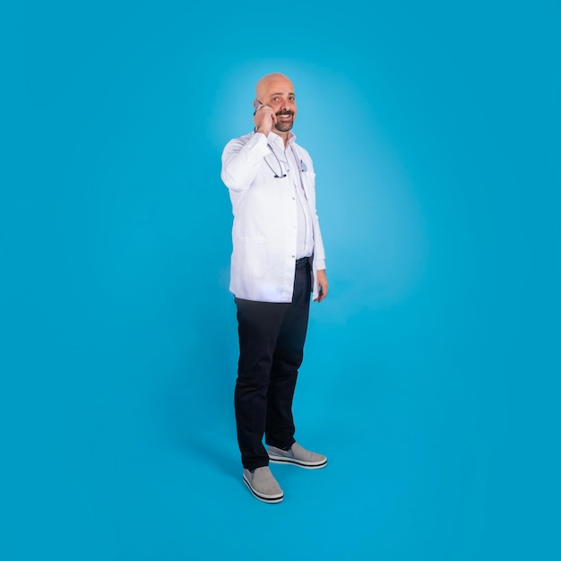 A man in a white coat and stethoscope is standing in front of a blue background