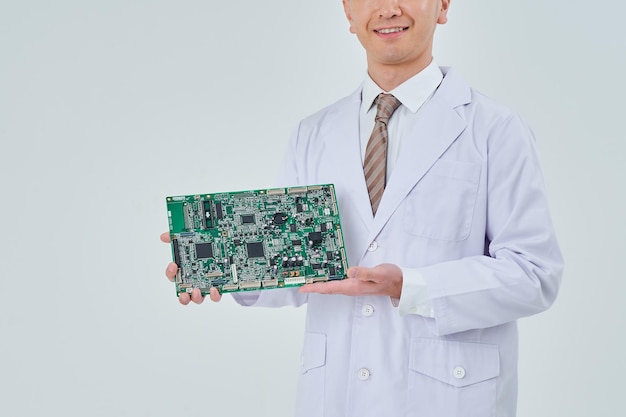 A man in a white coat with an electronic circuit