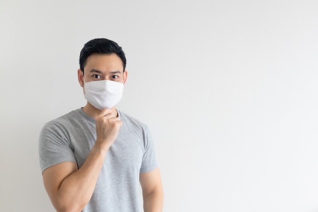 Man in white mask presenting the empty copy space on isolated background.