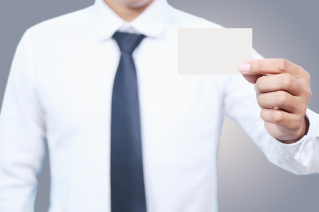 man in white shirt hold card on Gray background