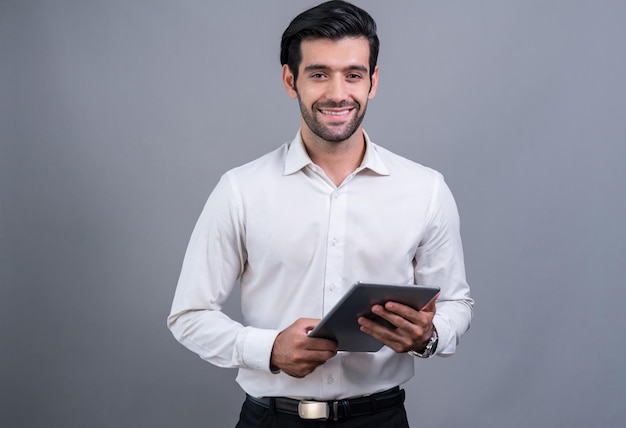 a man in a white shirt is holding a tablet.