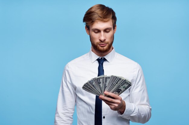 Man in white shirt with tie holding money in his hands wealth business