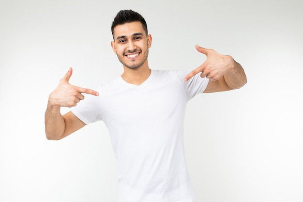 Man in a white t-shirt in a blank template on a white studio background.