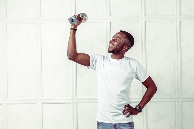 Man in white Tshirt holding money