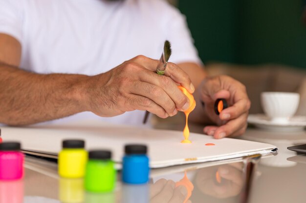 man in white tshirt practicing art therapy