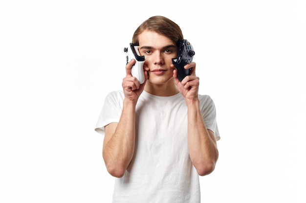 Man in white tshirt with joysticks in hands playing entertainment technology High quality photo