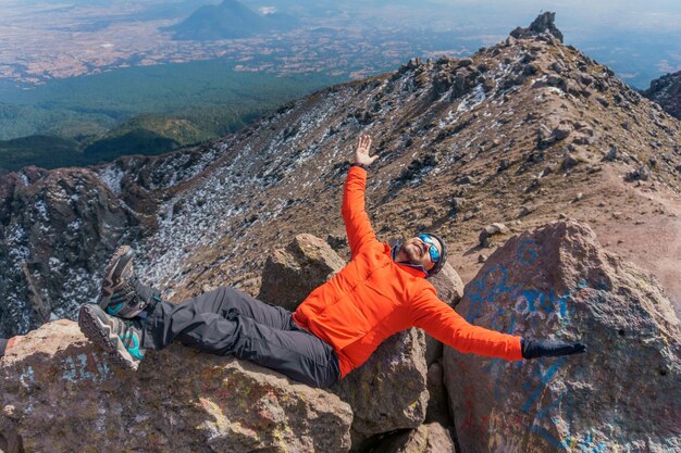 Man who hikers enjoys a break at the top of the mountain Selective focus