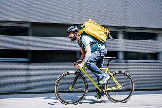 Man who works delivering food by courier at high speed through the city.