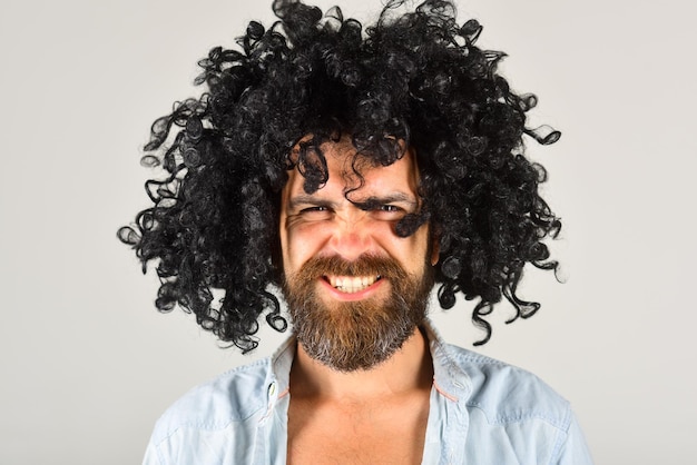 Man in wig. Smiling man in curly wig. Smile. Close up portrait of smiling bearded man. Isolated. Bearded man.