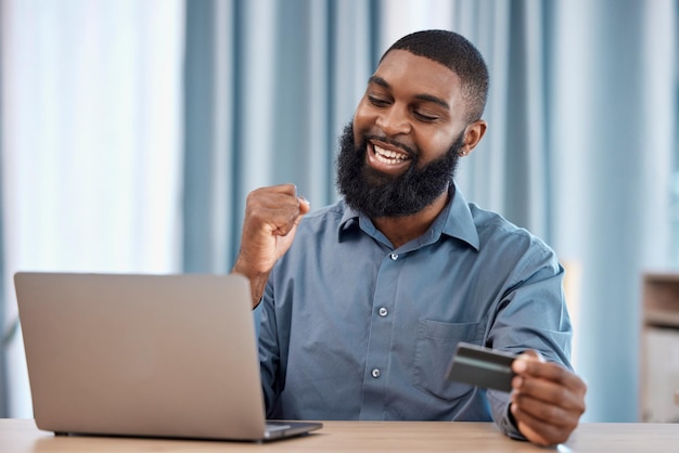 Man winner and credit card on laptop for success winning e commerce payment or investment African trader on computer and yes for business banking finance goals or profit sales and trading