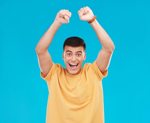 Man winner and yes for student success college news and celebration for winning goals or achievement in studio happy portrait of young person in wow excited and fist for power on blue background