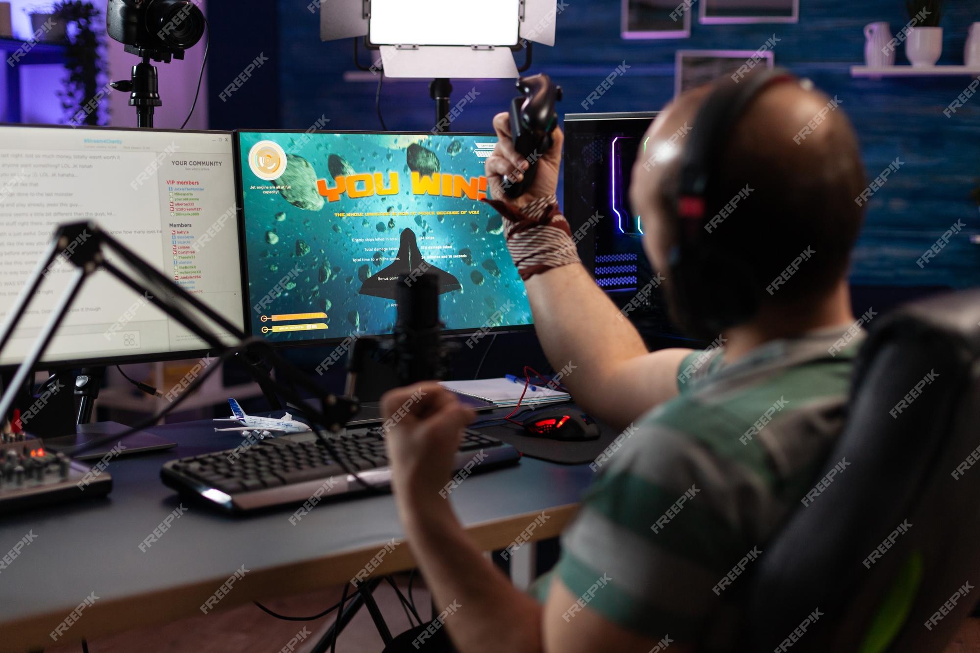 Premium Photo  Happy person live streaming video games tournament online  with multiple players, playing action esport game on computer. male  streamer with headset enjoying gaming competition.