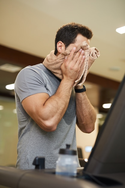 Man Wiping Sweat in Workout