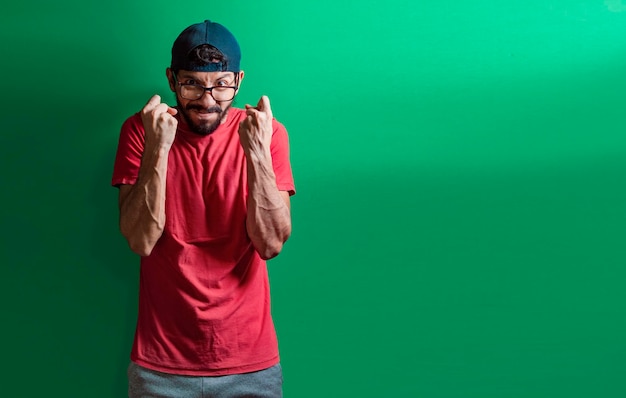 Man with angry expression isolated man in cap with anger
expression on isolated background concept of angry person clenching
fists aggressive people showing fists