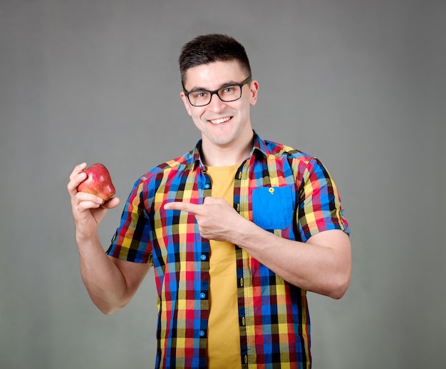 Man with apple isolated on gray background