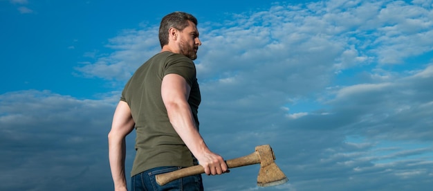 Man with axe woodsman man hold ax brutal man on sky background