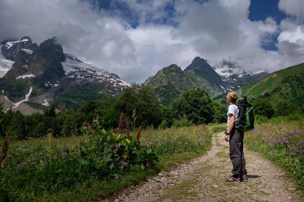 Man with backpack hiking in mountains Travel Lifestyle success concept