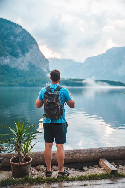 Man with backpack looking at hallstatt sea