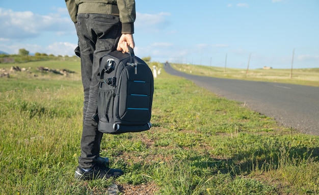 Man with backpack standing on the road