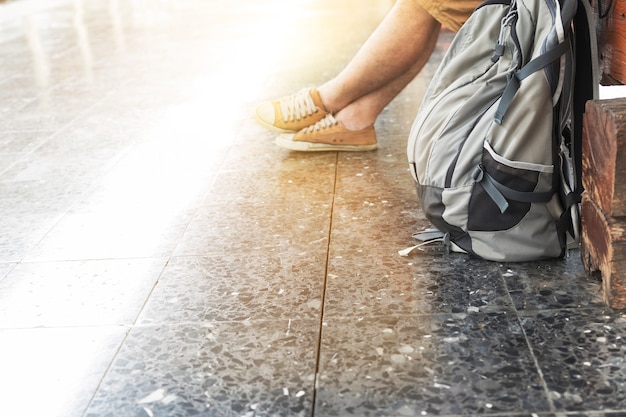 Man with backpack waiting for train at train station